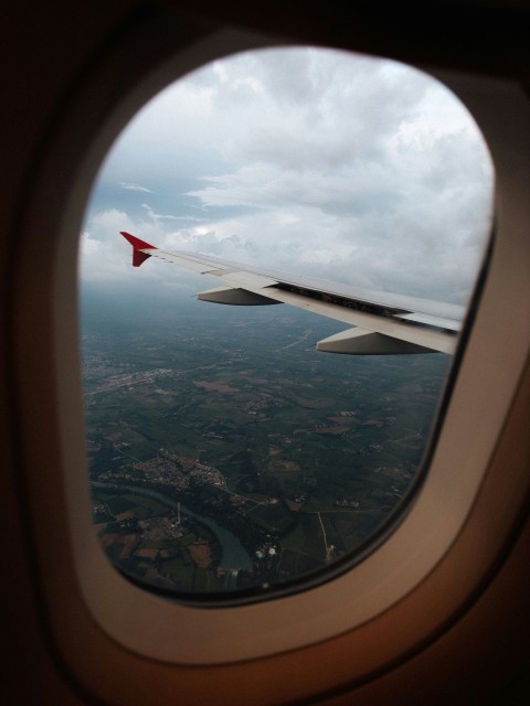 a view of the wing of an airplane from a window FyQgu