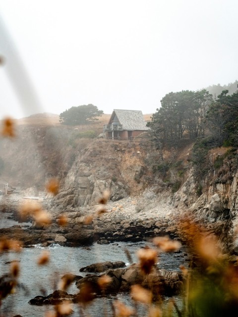 brown house near river during daytime