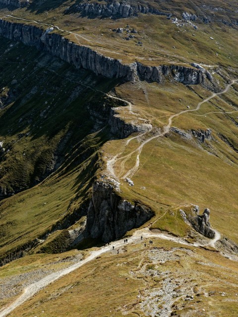 a group of people walking up the side of a mountain