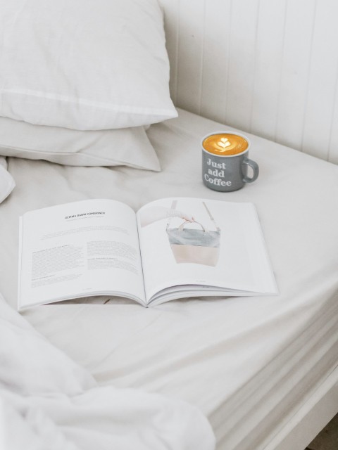 ceramic mug beside opened book