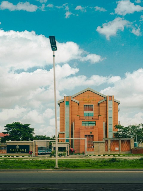 a red brick building sitting on the side of a road