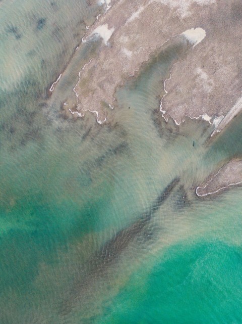 aerial view of green ocean water during daytime oLCun22P1