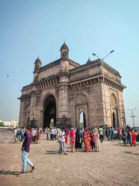 a group of people standing in front of a large building