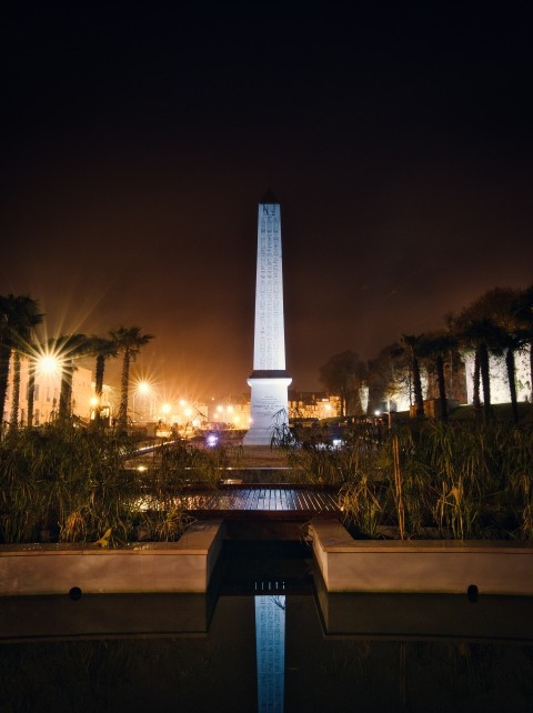 a very tall obelisk lit up at night