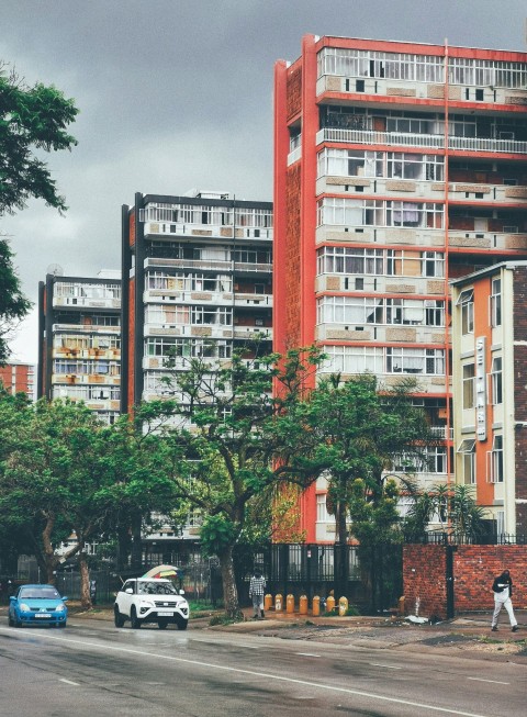 a tall red building sitting on the side of a road