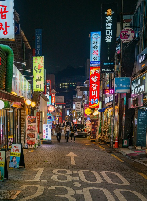 a city street filled with lots of neon signs