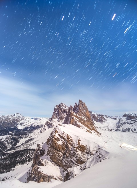 a snow covered mountain with stars in the sky