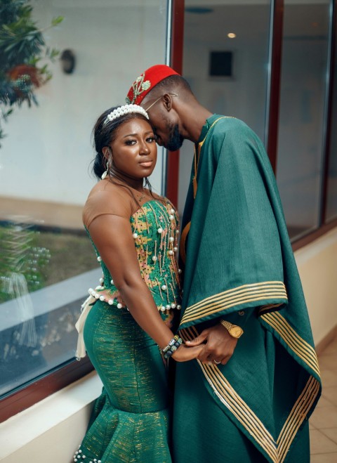 a man and woman dressed in traditional african clothing