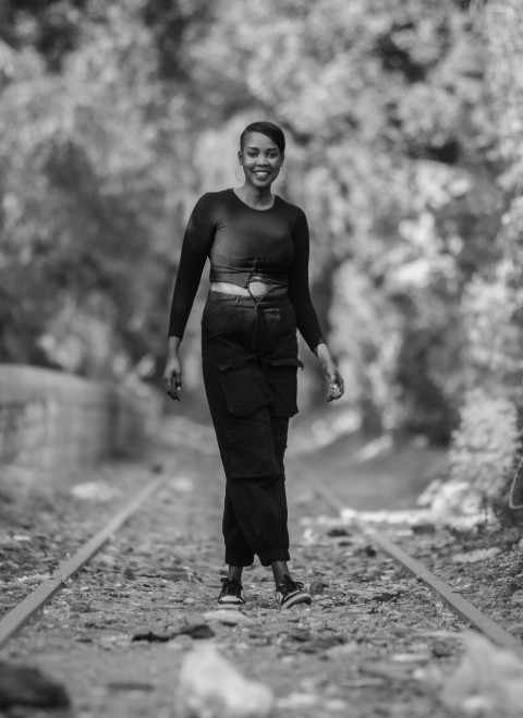 a black and white photo of a person on a train track