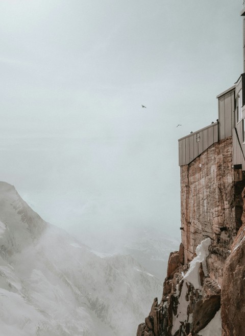 a person standing on top of a snow covered mountain