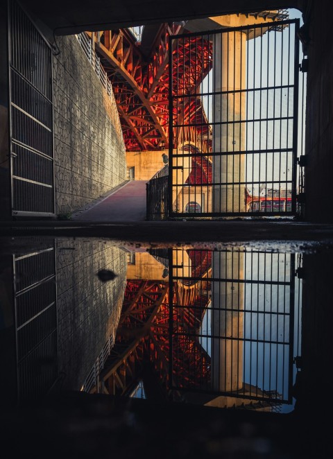 a reflection of the eiffel tower in a pool of water