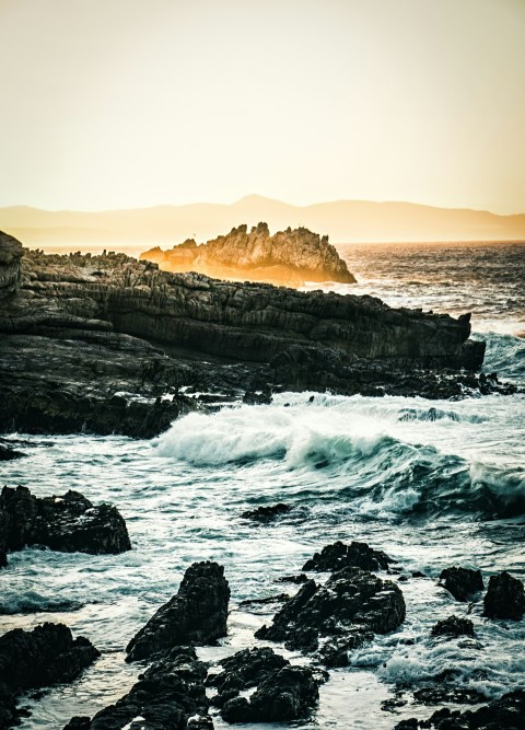 rock formation surrounded by sea