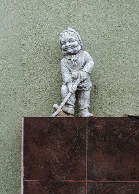 a statue of a boy holding a baseball bat