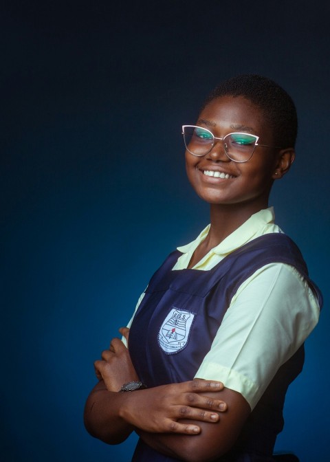 a woman wearing glasses and a blue apron