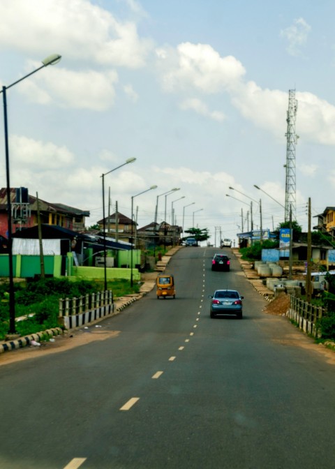 a car driving down a street next to tall buildings