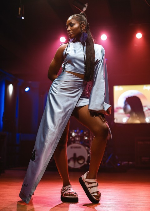 a woman in a silver dress on a stage