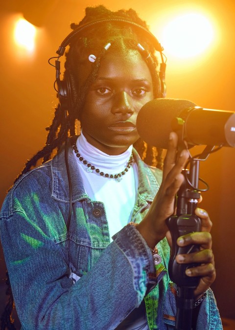 a woman with dreadlocks holding a microphone