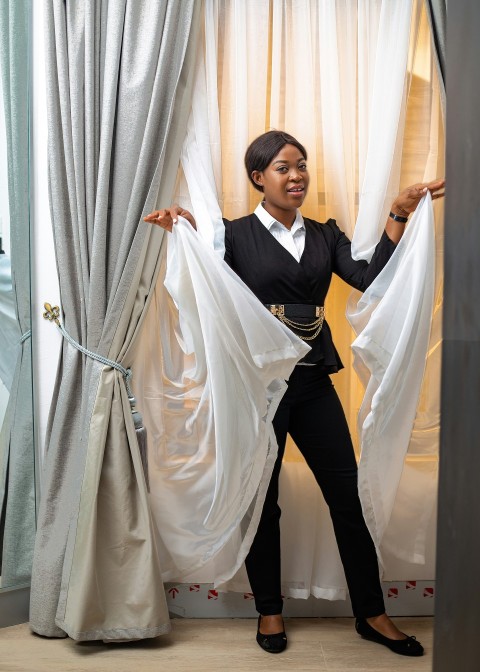 man in black and white formal suit standing beside white curtain 6xnLel