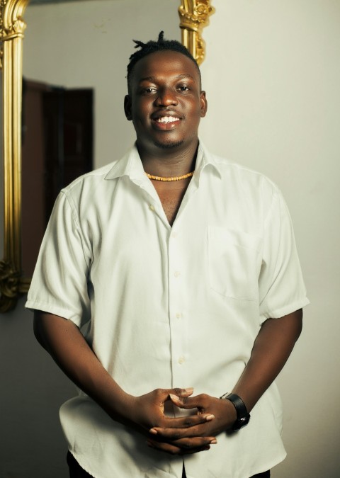 a man in a white shirt standing in front of a mirror