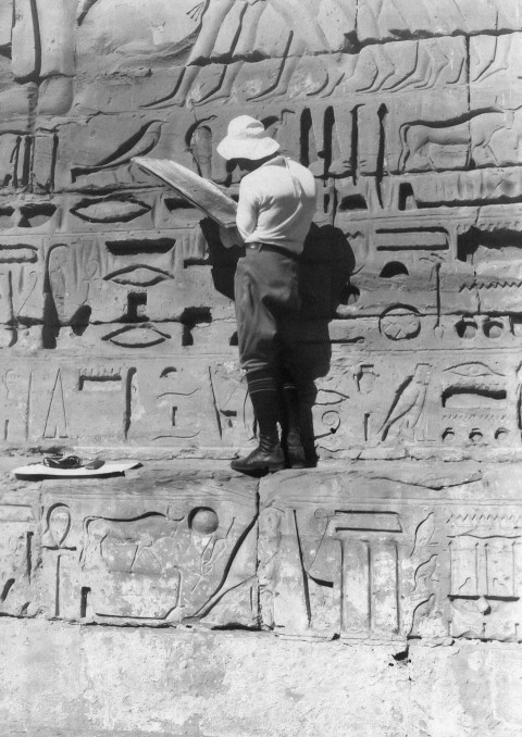 a little boy that is standing in front of a wall NUSOQb