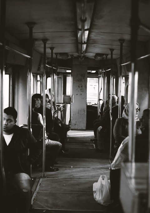 man in black jacket sitting on train seat