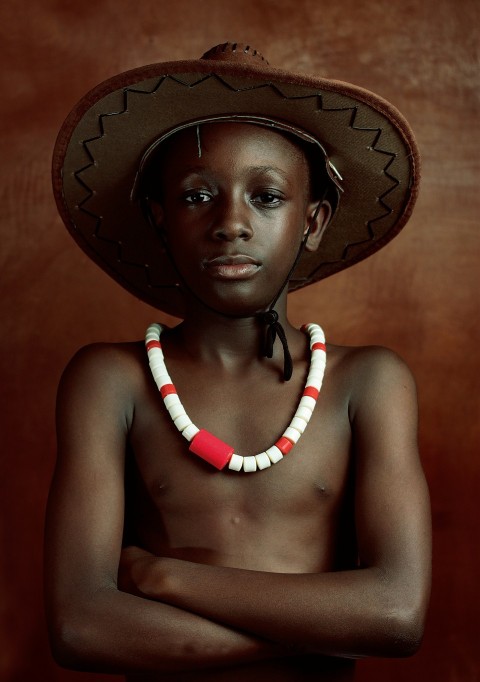 a young boy with a hat on his head