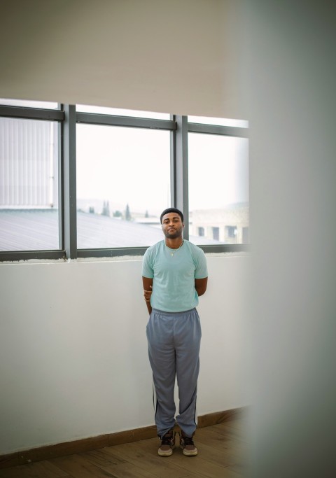 a man standing in front of a large window