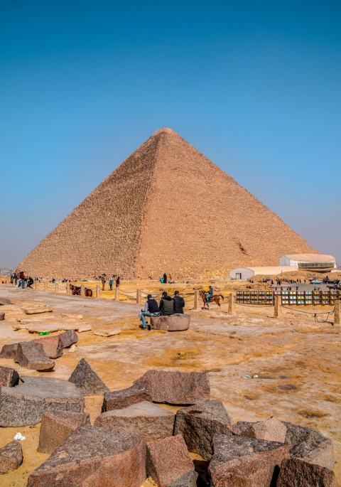 people standing near pyramid under blue sky during daytime V2