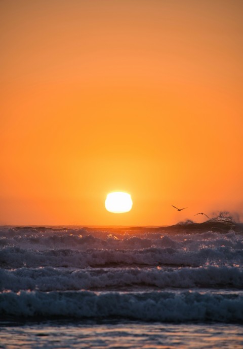 sea waves crashing on shore during sunset fqMC