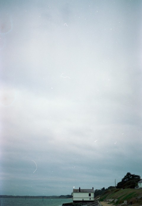 a lighthouse on the shore of a body of water