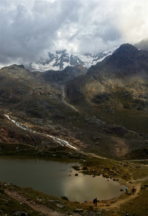 a couple of people standing on top of a mountain