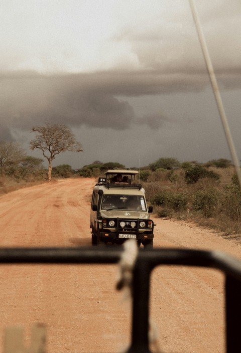 black suv on dirt road during daytime