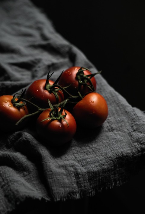 red tomato on black textile n