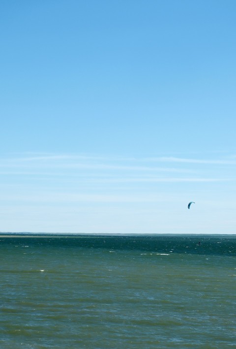 a person riding a surf board on a large body of water