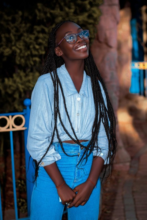 a woman with long braids and a blue shirt