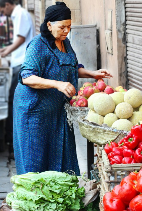 woman in blue dress holding basket of fruits ez