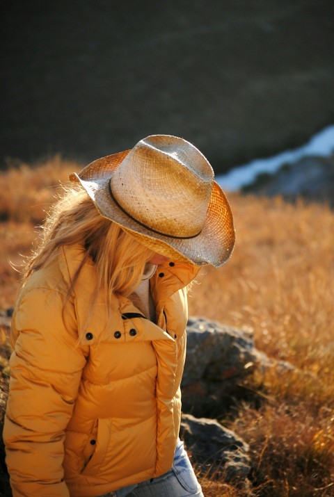 woman wearing yellow bubble jacket close up photography