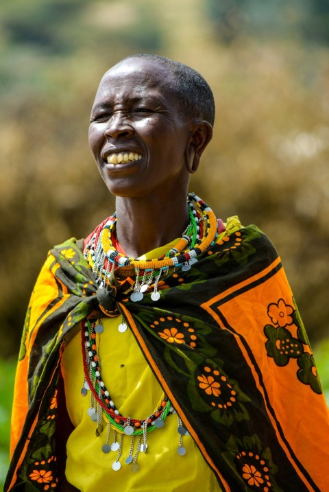 man in yellow shirt with green and orange floral scarf aVOQwwp