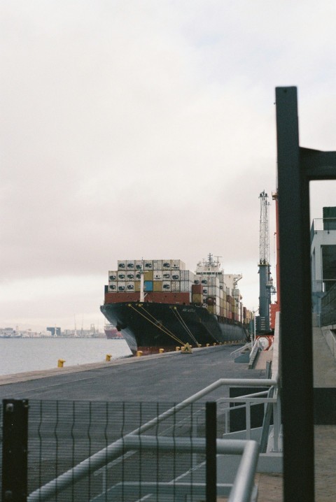 a large cargo ship docked at a dock