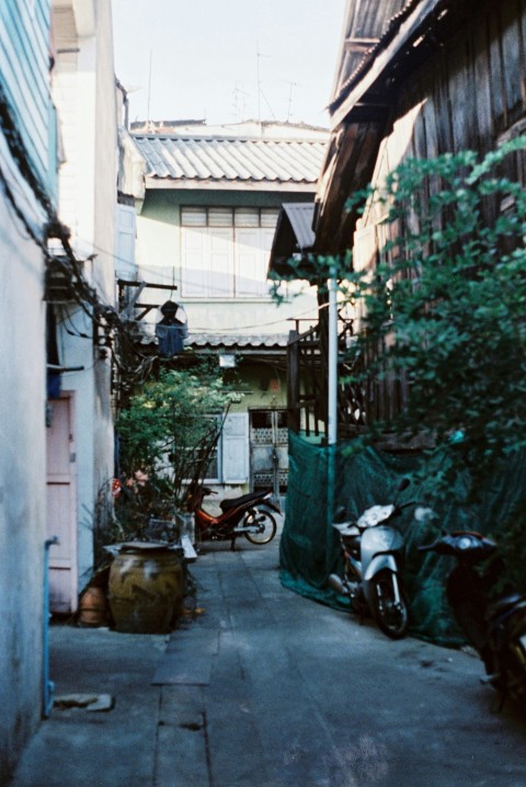 a narrow alley with a motorcycle parked on the side