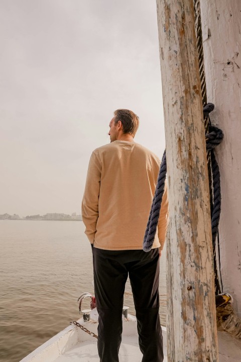 a man standing on a boat in the water