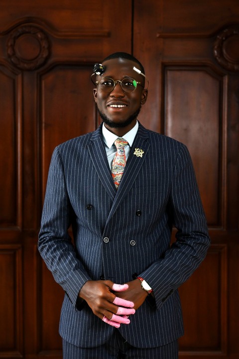 a man in a suit and tie posing for a picture