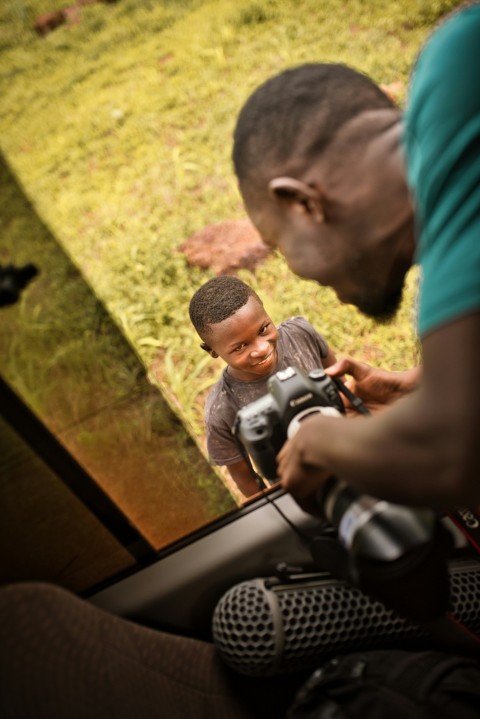 a man and a woman looking through a camera 7Szyr