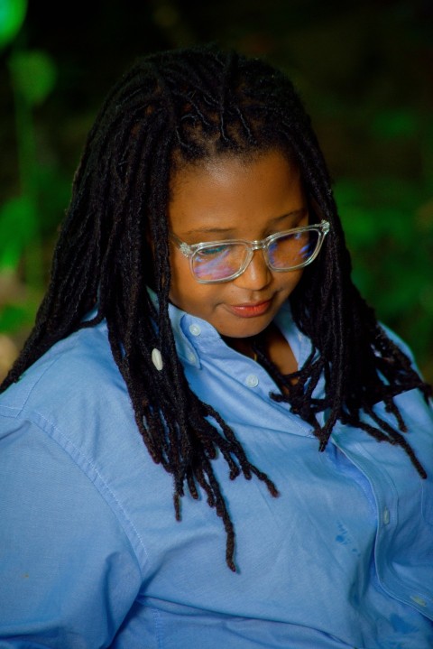 a woman with glasses looking at her cell phone