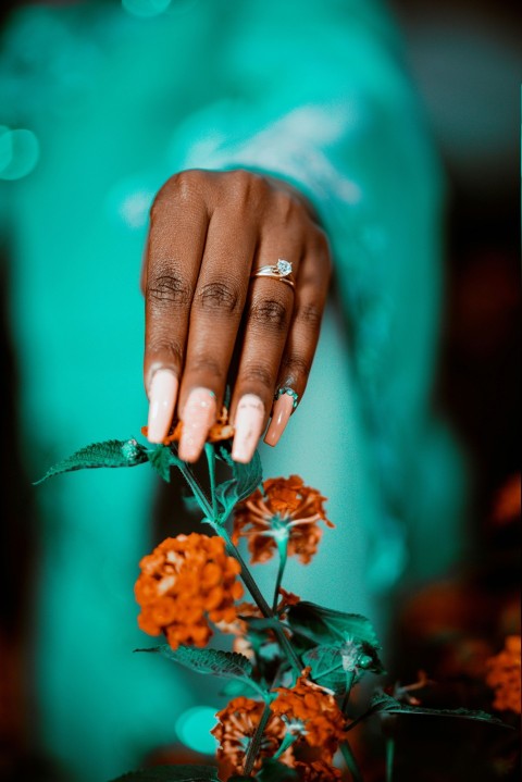 a woman holding a flower in her hand