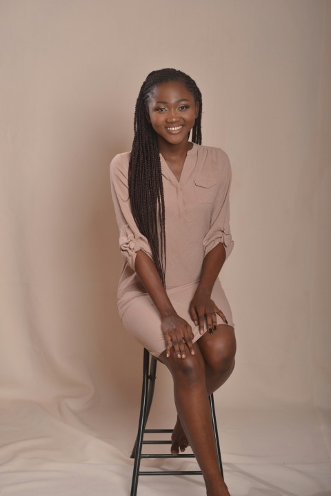 a woman sitting on a chair with a smile on her face