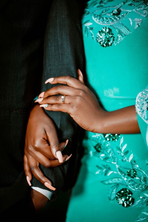 a close up of a person holding another persons hand IqqTi