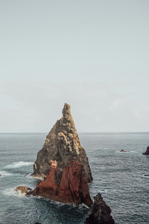 a rock outcropping in the middle of the ocean