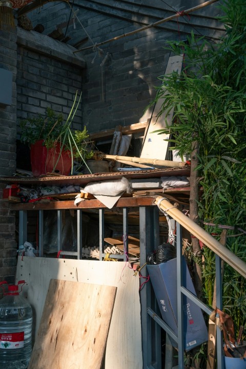 a pile of wood sitting next to a building