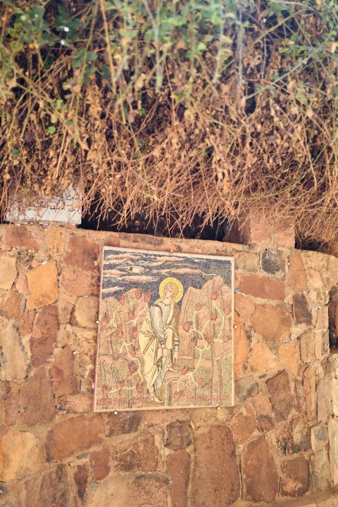 a stone wall with a painting on it